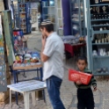 Kid selling bags of popcorn to tourists
